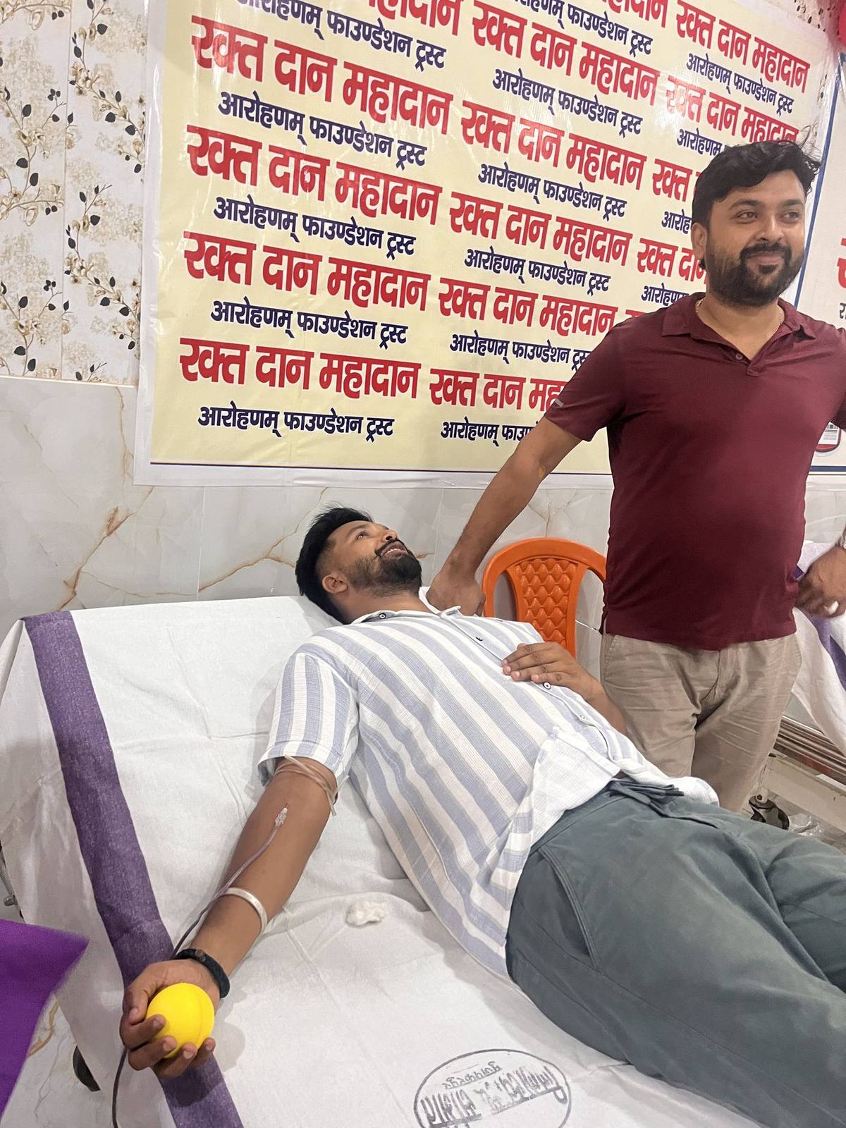 Volunteer checking on a blood donor at the camp