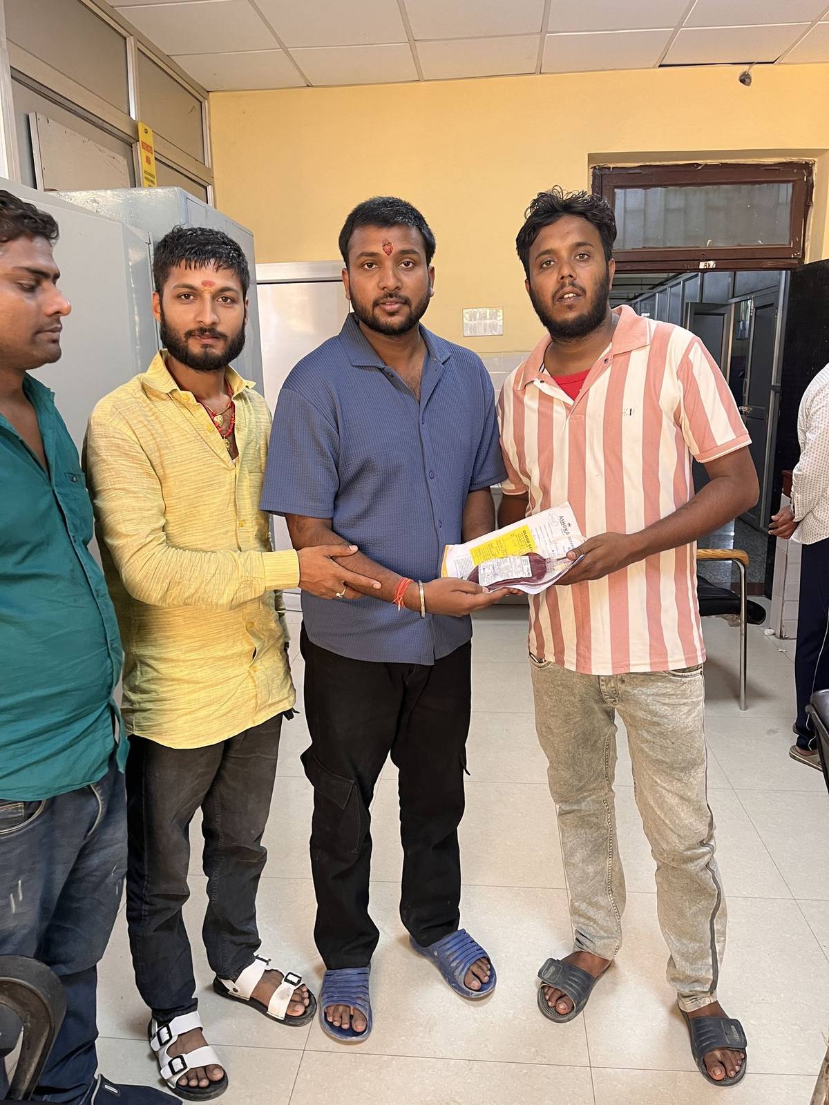 Trust members handing over donated blood unit to the blood bank