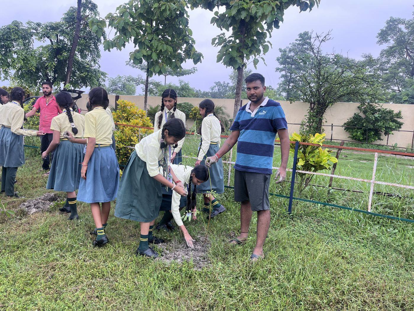 Volunteer guiding students during the Green Drive plantation